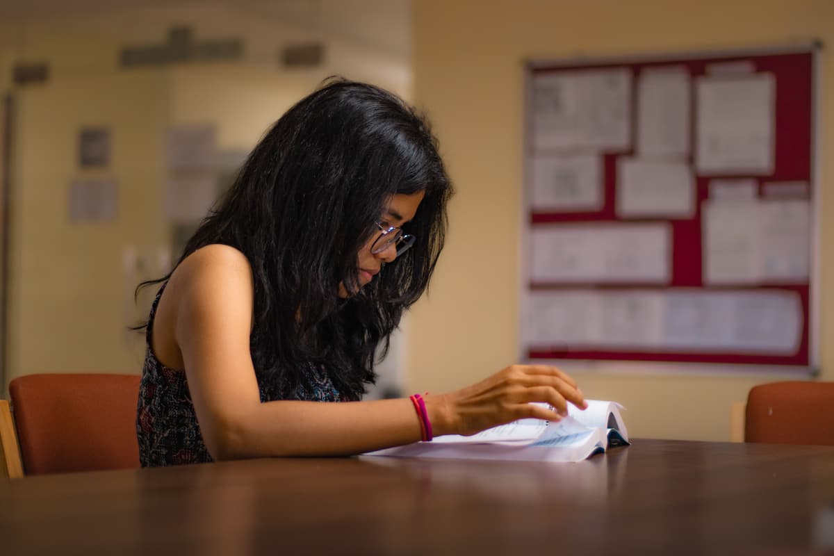 Student reading at a desk